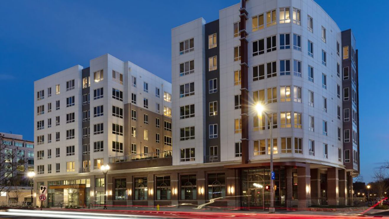 The Unity at Ballston affordable housing building at dusk.